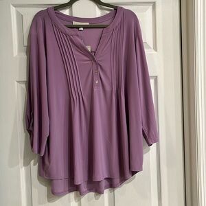 A classic blouse with pleats in the front and back with3/4 button sleeves.